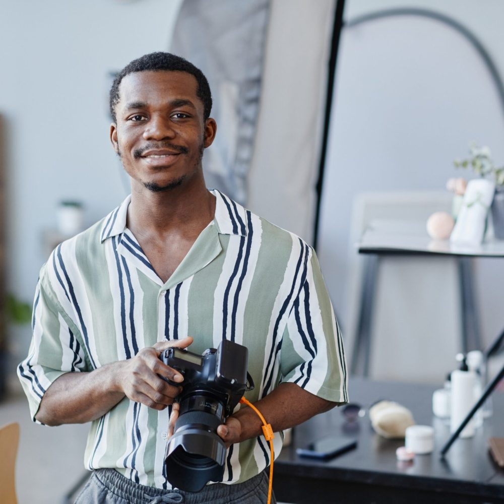 portrait-of-black-young-man-with-photo-camera-2023-11-27-04-59-24-utc-scaled.jpg